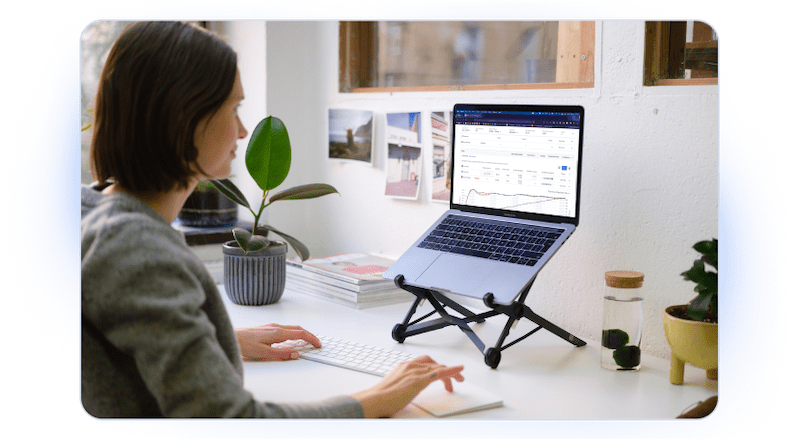 A Woman Is Looking At A Laptop Computer on A Stand